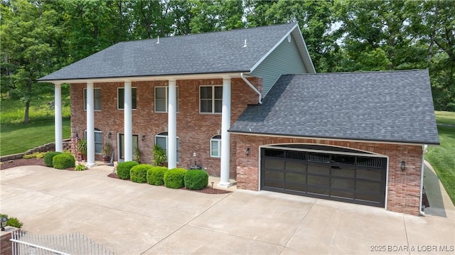 149 Snead Cir, Lake Ozark, MO 65049 - neoclassical / greek revival house with driveway, roof with shingles, a garage, brick siding, and a front yard