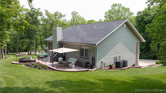 149 Snead Cir, Lake Ozark, MO 65049 - back of house with an outdoor fire pit, a patio, a chimney, a lawn, and view of wooded area