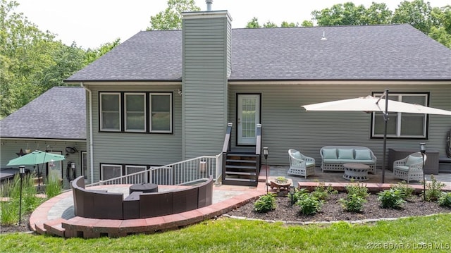 149 Snead Cir, Lake Ozark, MO 65049 - back of house with roof with shingles, entry steps, and a chimney