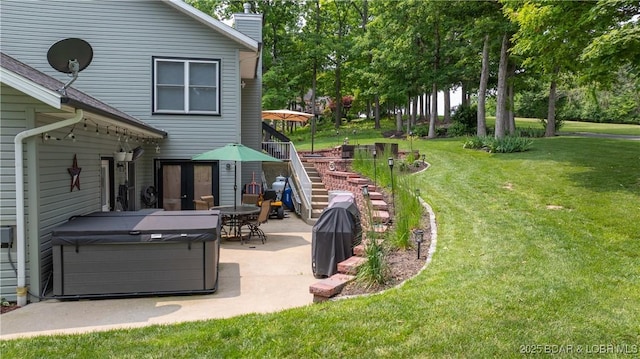 149 Snead Cir, Lake Ozark, MO 65049 - view of grassy yard featuring a hot tub, a patio, and stairs