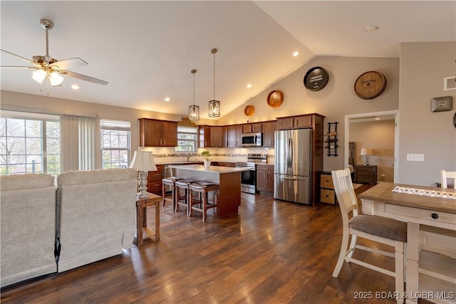 4715 Inlet Ln, Osage Beach, MO 65065 - kitchen featuring stainless steel appliances, ceiling fan, light countertops, a breakfast bar area, and a center island