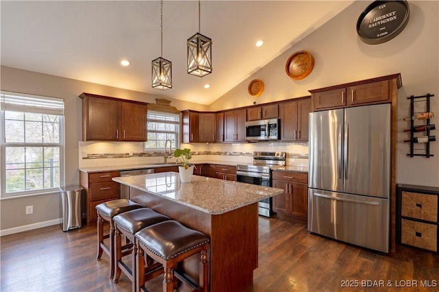 4715 Inlet Ln, Osage Beach, MO 65065 - kitchen with appliances with stainless steel finishes, dark wood-style floors, a sink, tasteful backsplash, and a center island