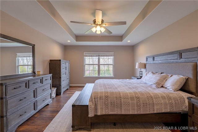 4715 Inlet Ln, Osage Beach, MO 65065 - bedroom featuring multiple windows, dark wood-type flooring, a raised ceiling, baseboards, and recessed lighting