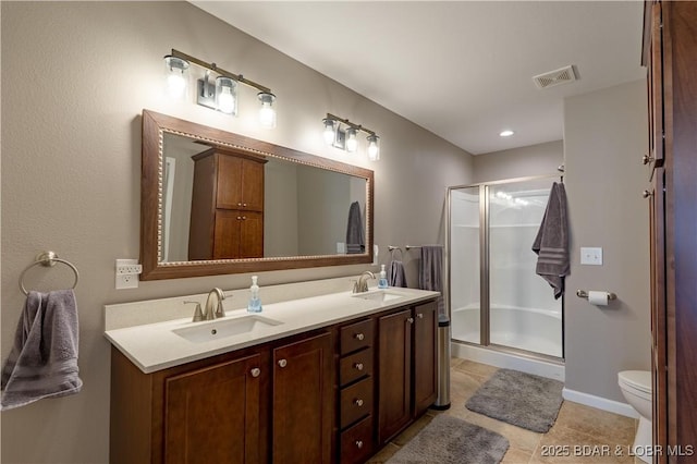 4715 Inlet Ln, Osage Beach, MO 65065 - full bath with double vanity, a stall shower, toilet, and tile patterned flooring