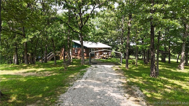 13 Bunker Rd, Eldon, MO 65026 - view of front of property featuring stairs, gravel driveway, a wooden deck, and a front yard
