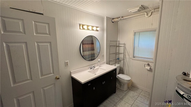 13 Bunker Rd, Eldon, MO 65026 - full bathroom with vanity, toilet, marble look tiles, and wood walls