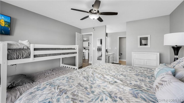 4897 Bridgepoint Dr Unit 311, Osage Beach, MO 65065 - bedroom featuring a ceiling fan, baseboards, and wood finished floors