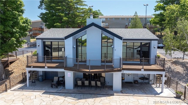 4897 Bridgepoint Dr Unit 311, Osage Beach, MO 65065 - rear view of property featuring a chimney and a shingled roof