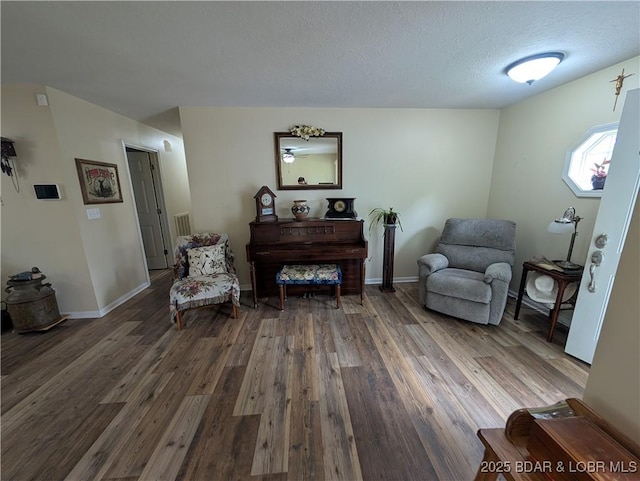 1001 Ha Ha Tonka Rd, Camdenton, MO 65020 - sitting room with wood finished floors, a textured ceiling, and baseboards