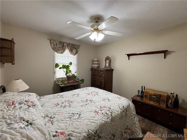1001 Ha Ha Tonka Rd, Camdenton, MO 65020 - bedroom featuring wood finished floors, a ceiling fan, and a textured ceiling