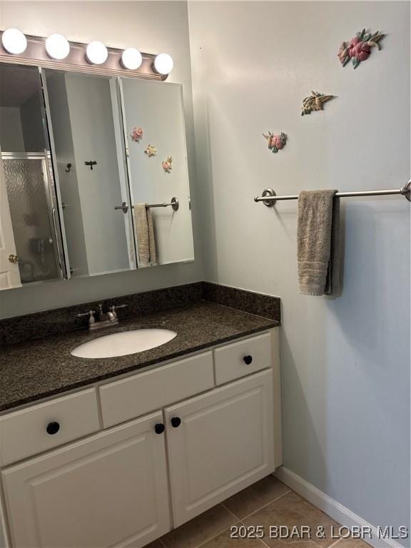 1001 Ha Ha Tonka Rd, Camdenton, MO 65020 - full bath featuring vanity, a stall shower, tile patterned flooring, and baseboards