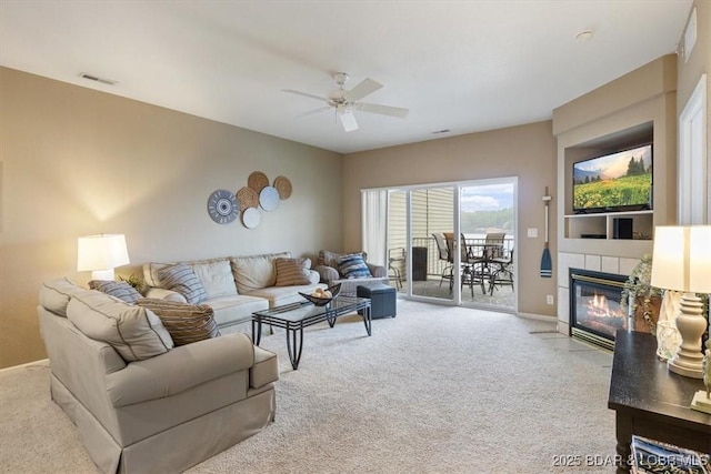 1181 Jeffries Rd Unit B107, Osage Beach, MO 65065 - living room featuring carpet flooring, a ceiling fan, a fireplace, and baseboards