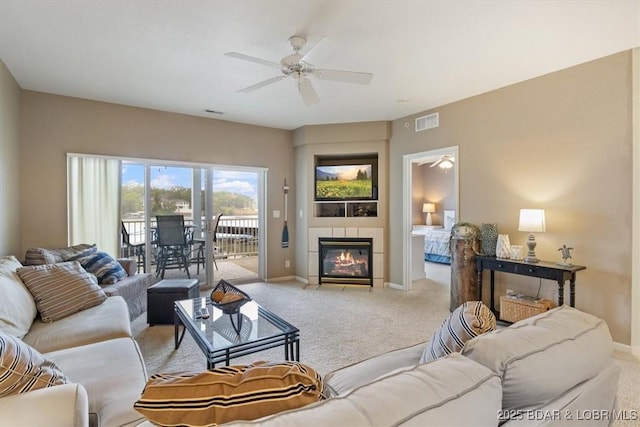 1181 Jeffries Rd Unit B107, Osage Beach, MO 65065 - living room with light carpet, ceiling fan, baseboards, and a tiled fireplace
