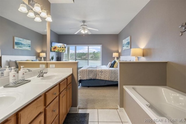 1181 Jeffries Rd Unit B107, Osage Beach, MO 65065 - bathroom with double vanity, a bath, a ceiling fan, tile patterned floors, and ensuite bathroom