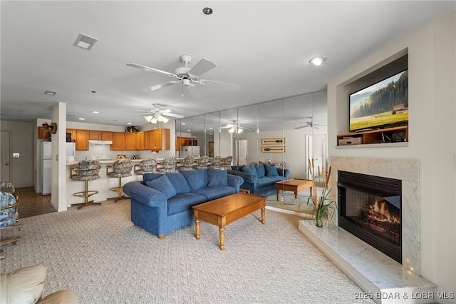 335 Vision Dr Unit 2B, Camdenton, MO 65020 - living area featuring a ceiling fan, a premium fireplace, recessed lighting, and light carpet