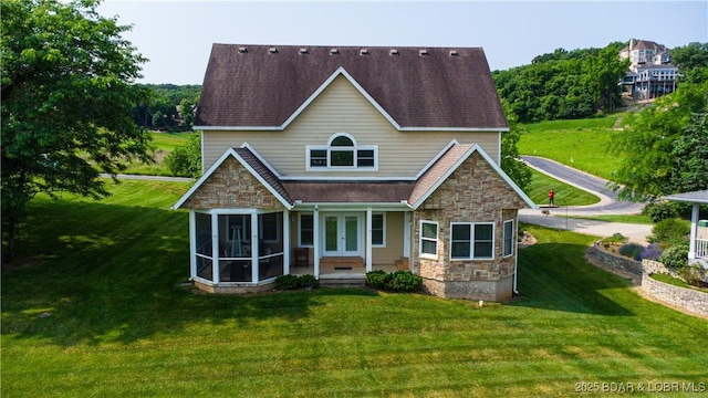 915 Bear Cave Way, Camdenton, MO 65020 - view of front of house featuring stone siding, a front yard, french doors, and a sunroom