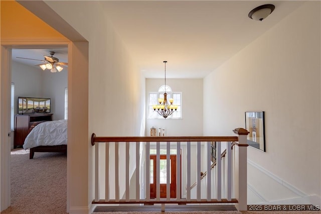 915 Bear Cave Way, Camdenton, MO 65020 - corridor with a chandelier, carpet flooring, and an upstairs landing