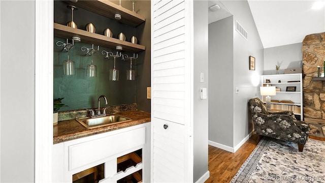 2151 Portside Ln, Osage Beach, MO 65065 - indoor wet bar featuring wood finished floors, vaulted ceiling, and baseboards