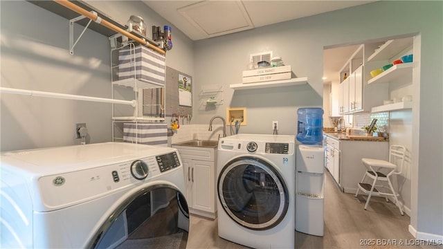 2151 Portside Ln, Osage Beach, MO 65065 - laundry area with separate washer and dryer, light wood-style flooring, and cabinet space