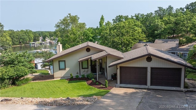 2151 Portside Ln, Osage Beach, MO 65065 - view of front of home featuring a front lawn, a chimney, a water view, a garage, and a shingled roof