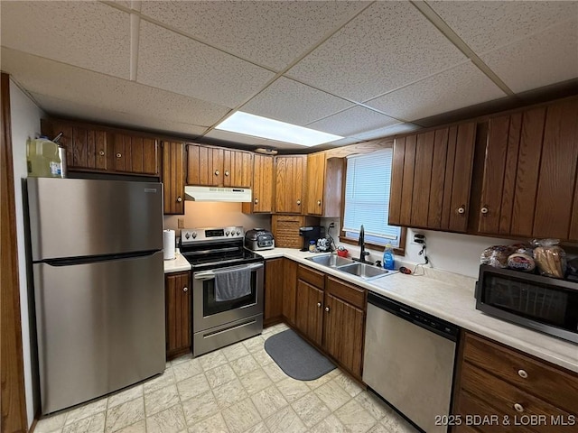 29720 Uu Hwy, Warsaw, MO 65355 - kitchen with appliances with stainless steel finishes, a sink, under cabinet range hood, light countertops, and a drop ceiling
