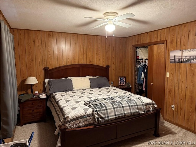 29720 Uu Hwy, Warsaw, MO 65355 - bedroom featuring light carpet, wooden walls, a closet, a textured ceiling, and ceiling fan