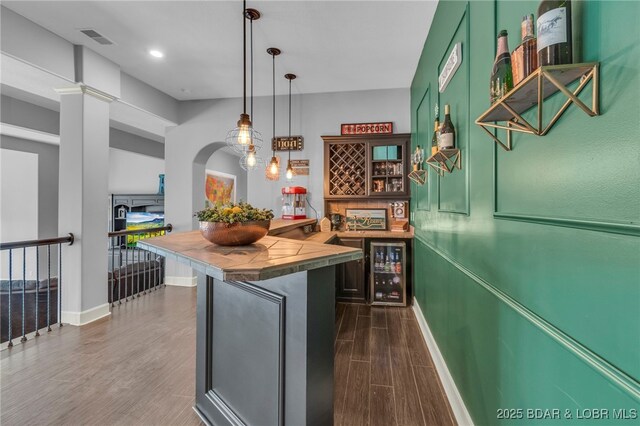 5938 N Chatham Ave, Kansas City, MO 64151 - kitchen featuring dark wood-style floors, green cabinetry, beverage cooler, tile countertops, and baseboards