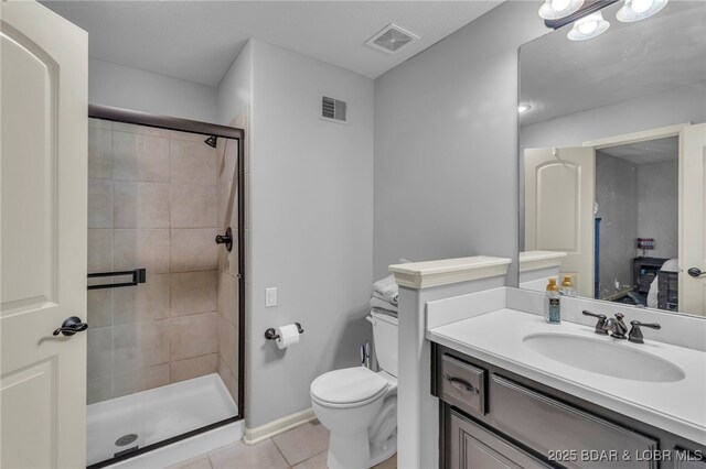 5938 N Chatham Ave, Kansas City, MO 64151 - bathroom featuring tile patterned flooring, toilet, vanity, a stall shower, and baseboards