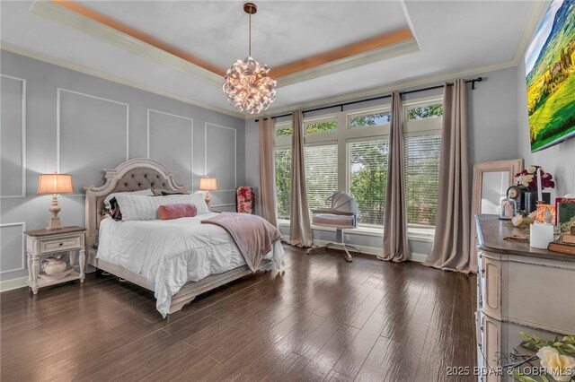 5938 N Chatham Ave, Kansas City, MO 64151 - bedroom with a tray ceiling, a chandelier, ornamental molding, dark wood-type flooring, and baseboards