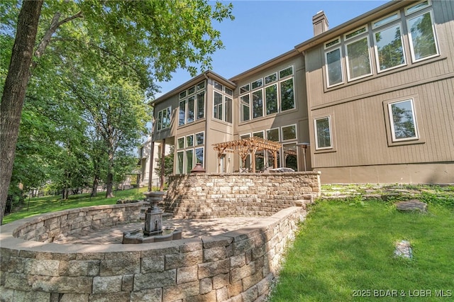 5938 N Chatham Ave, Kansas City, MO 64151 - back of property featuring a chimney and a yard