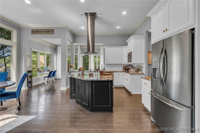 5938 N Chatham Ave, Kansas City, MO 64151 - kitchen with appliances with stainless steel finishes, light stone counters, island exhaust hood, ornamental molding, and tasteful backsplash