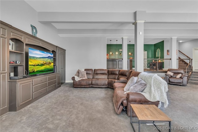 5938 N Chatham Ave, Kansas City, MO 64151 - living area with carpet, decorative columns, beamed ceiling, and stairs