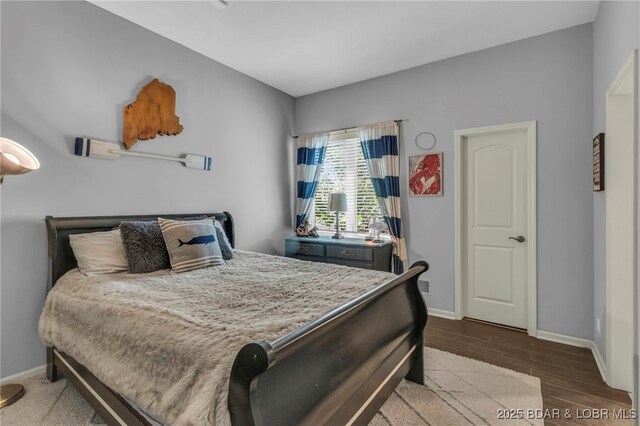 5938 N Chatham Ave, Kansas City, MO 64151 - bedroom featuring baseboards and wood finished floors