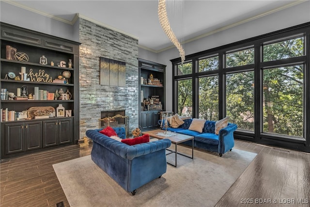 5938 N Chatham Ave, Kansas City, MO 64151 - living area featuring a stone fireplace, ornamental molding, wood finished floors, and built in features