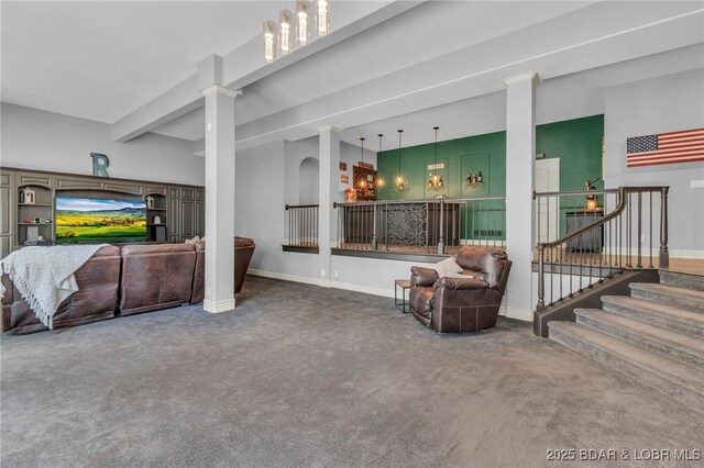 5938 N Chatham Ave, Kansas City, MO 64151 - living area featuring carpet flooring, decorative columns, baseboards, and stairs