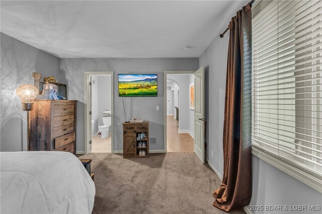 5938 N Chatham Ave, Kansas City, MO 64151 - carpeted bedroom featuring baseboards and ensuite bath
