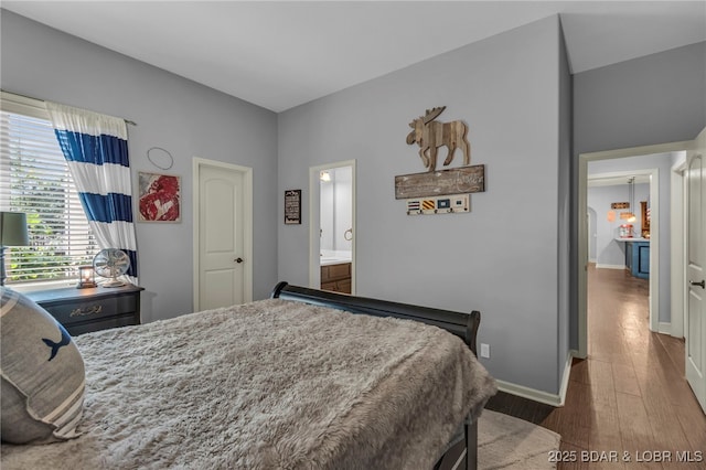 5938 N Chatham Ave, Kansas City, MO 64151 - bedroom with wood finished floors, baseboards, and ensuite bathroom