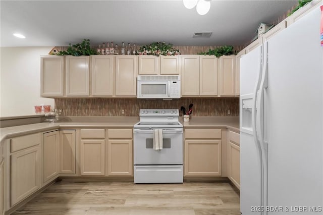 199 Bristol Bay Dr Unit 2A, Lake Ozark, MO 65049 - kitchen featuring white appliances, light countertops, light wood-style floors, and recessed lighting