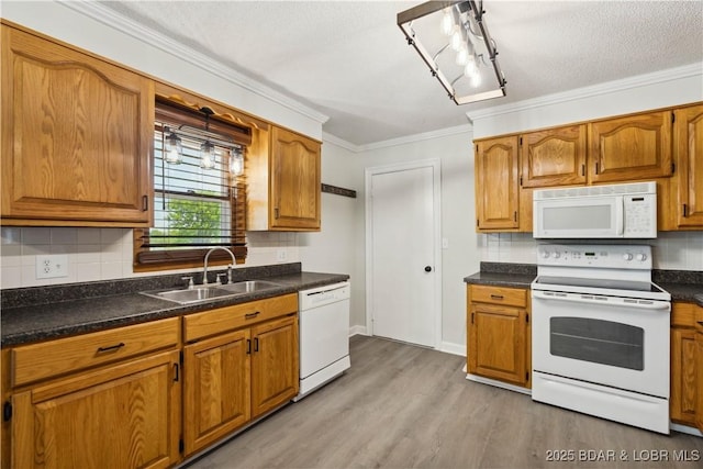 107 Haynes St, Eldon, MO 65026 - kitchen with white appliances, a sink, crown molding, light wood-style floors, and brown cabinets
