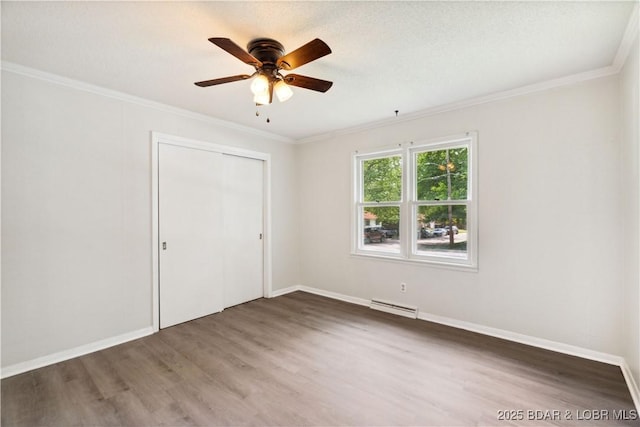 107 Haynes St, Eldon, MO 65026 - unfurnished bedroom with wood finished floors, crown molding, a closet, baseboards, and ceiling fan