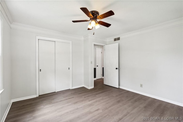107 Haynes St, Eldon, MO 65026 - unfurnished bedroom with ornamental molding, wood finished floors, baseboards, and a closet