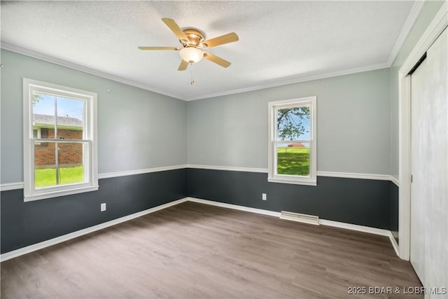 107 Haynes St, Eldon, MO 65026 - spare room featuring wood finished floors, crown molding, ceiling fan, and baseboards