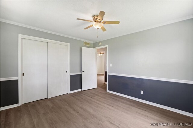 107 Haynes St, Eldon, MO 65026 - unfurnished bedroom with a closet, wood finished floors, baseboards, ceiling fan, and ornamental molding