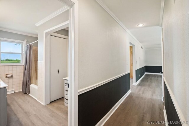 107 Haynes St, Eldon, MO 65026 - hallway with light wood-style flooring, crown molding, tile walls, a wainscoted wall, and recessed lighting