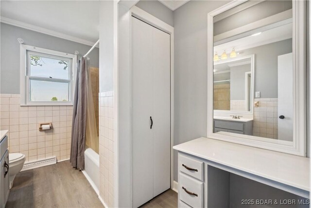 107 Haynes St, Eldon, MO 65026 - bathroom featuring tile walls, vanity, wood finished floors, shower / tub combo, and toilet