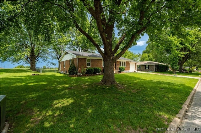 107 Haynes St, Eldon, MO 65026 - ranch-style house featuring a front lawn, brick siding, and a garage