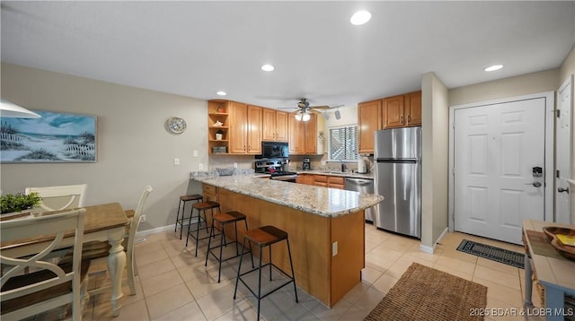 611 Lazy Days Rd Unit W1, Osage Beach, MO 65065 - kitchen with stainless steel appliances, a peninsula, open shelves, a sink, and a kitchen breakfast bar