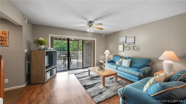 611 Lazy Days Rd Unit W1, Osage Beach, MO 65065 - living area featuring a ceiling fan, wood finished floors, and baseboards