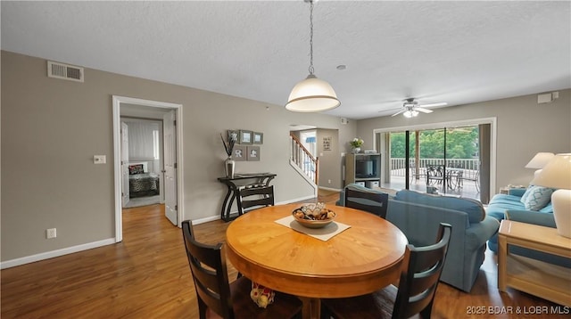 611 Lazy Days Rd Unit W1, Osage Beach, MO 65065 - dining area with stairs, wood finished floors, baseboards, ceiling fan, and a textured ceiling