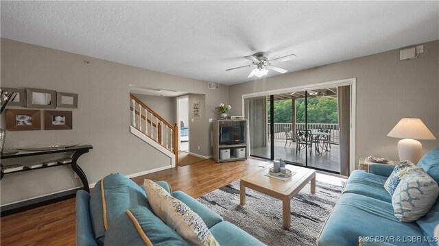 611 Lazy Days Rd Unit W1, Osage Beach, MO 65065 - living room with a ceiling fan, wood finished floors, stairway, and baseboards